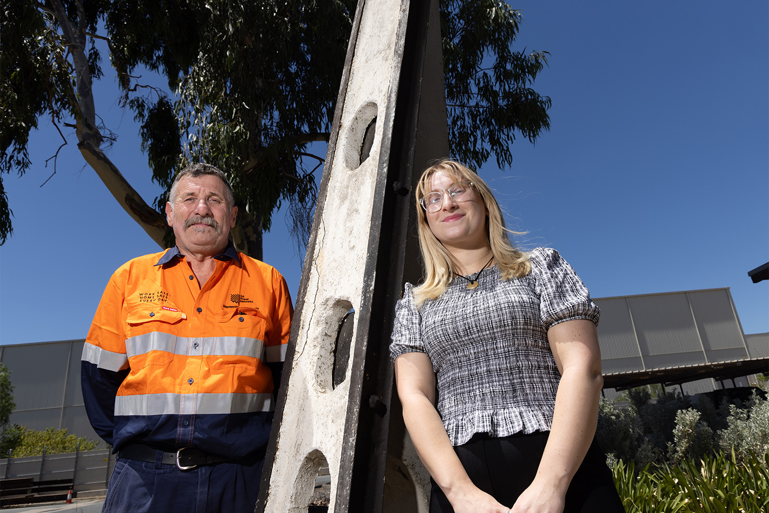 Brian and Kat Docking at the Stobie pole manufacturing facility with one of the first Stobie poles ever produced.